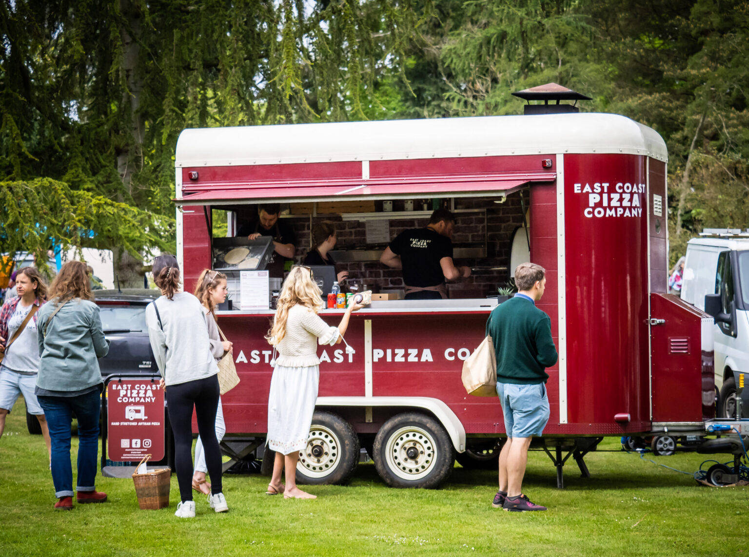 The Nag Box set up and serving guests at an outdoor event with the team behind the hatch